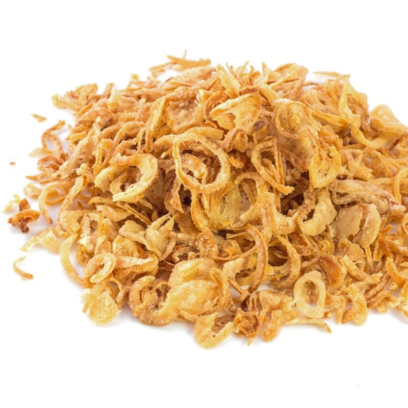 A close-up view of a pile of golden-brown crispy fried onions, showcasing their crunchy texture on a white background.
