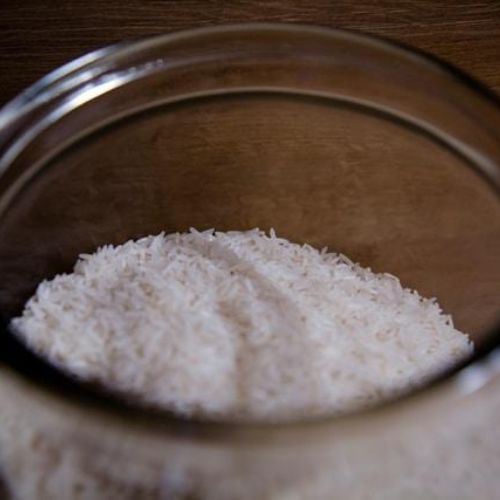 The inside of a glass jar filled with white rice grains